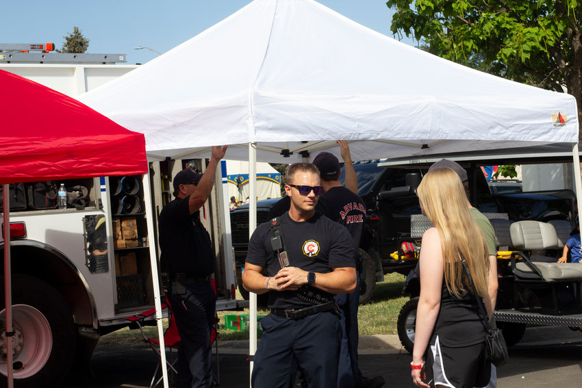 Members of the Arvada Fire Department interact with the crowd at the Wheat Ridge Carnation Festival.
